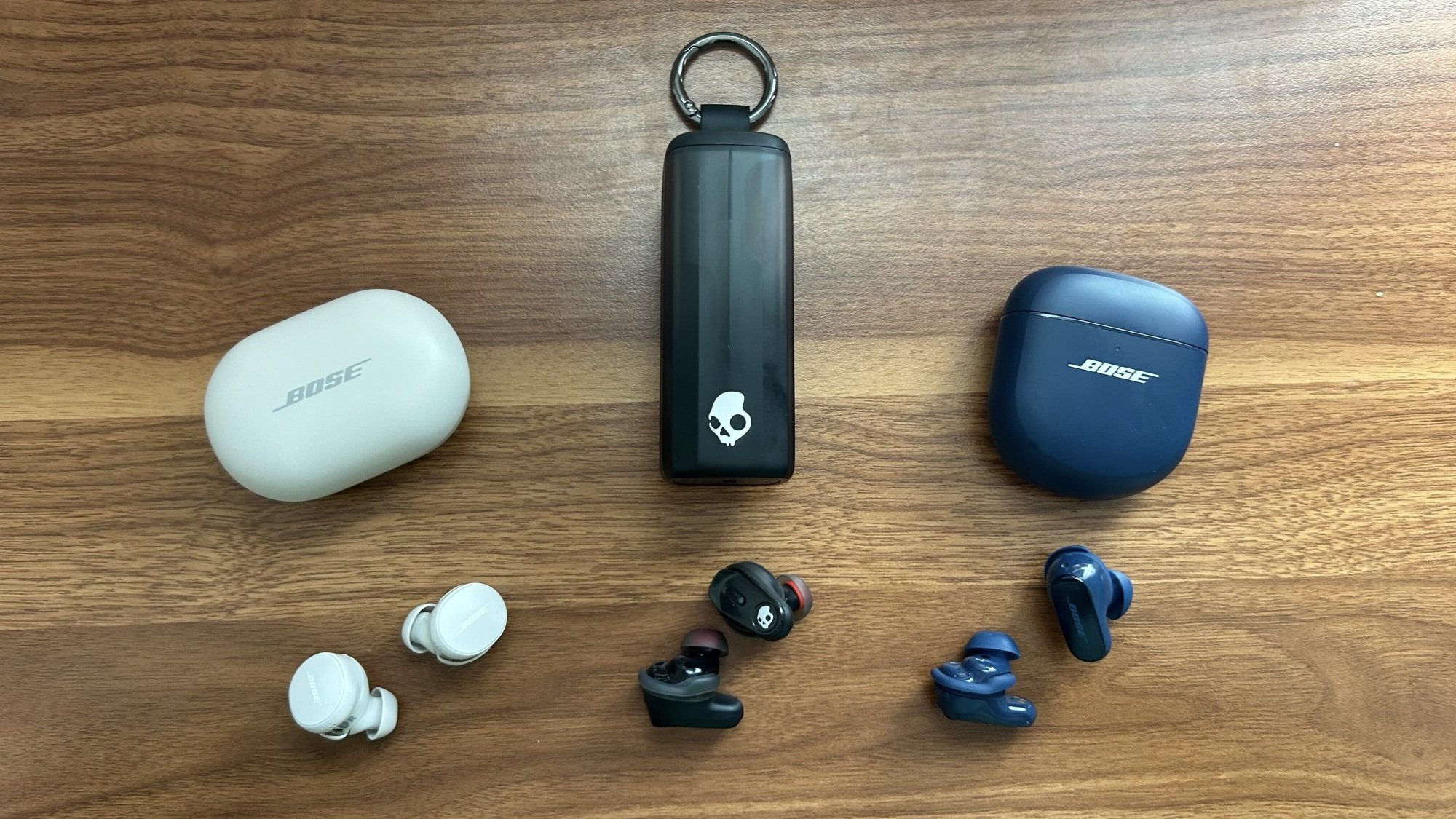 bose quietcomfort earbuds and their case, skullcandy earbuds and their case, and bose quietcomfort ultra earbuds and their case